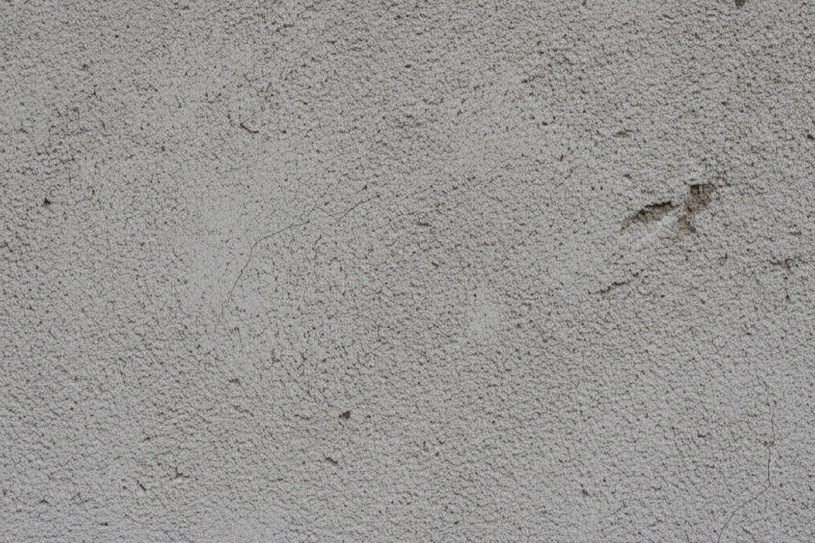 Nahaufnahme einer rauen Putzoberfläche an einer Gebäudewand